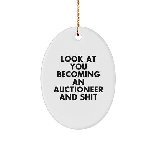 Funny Christmas Unique Gift for Auctioneer Friends - Oval Ornament with Look At You Becoming An Auctioneer And 'Shit' Quote - Gifts from Men to Colleagues - Image 1